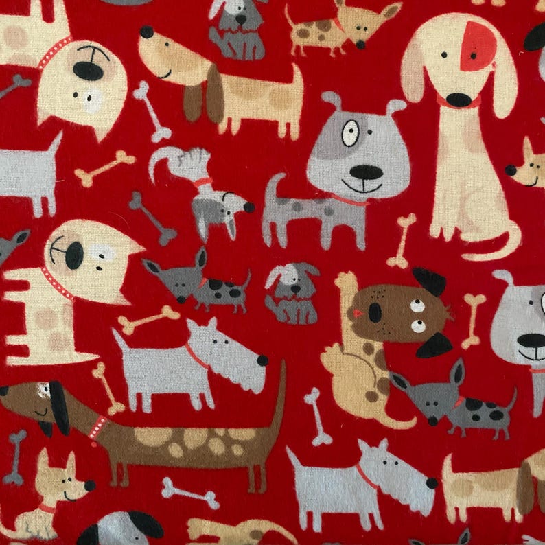 May include: Red fabric featuring a repeating pattern of cartoon dogs and bones. The dogs are in various colours and poses, with different markings. The design is playful and cheerful, suitable for children's items or pet accessories.