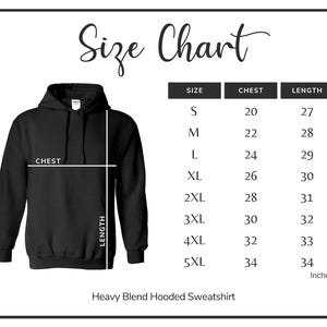 May include: Black hooded sweatshirt with a size chart. The chart lists sizes S to 5XL, chest measurements from 50.8 to 86.4 cm, and lengths from 68.6 to 86.4 cm. The text "Heavy Blend Hooded Sweatshirt" is at the bottom.