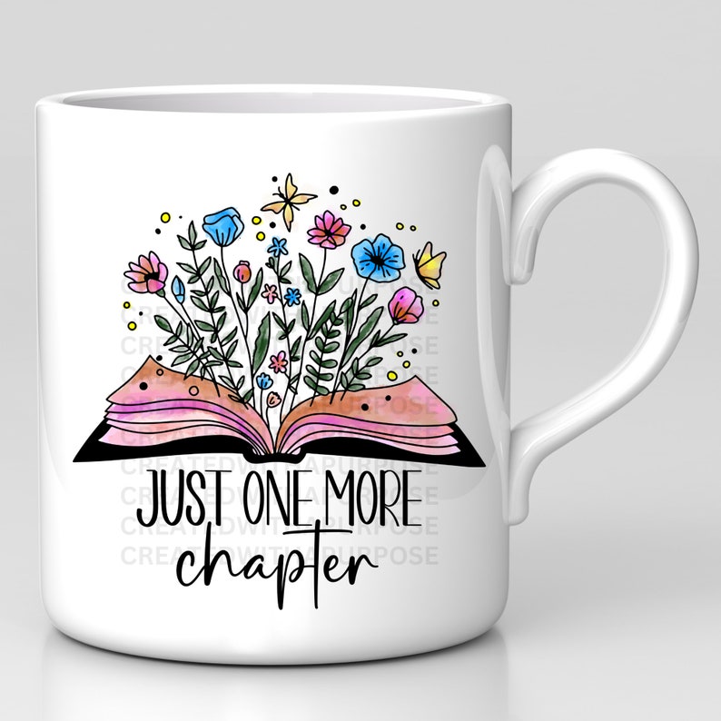 May include: White ceramic mug featuring a colorful illustration of an open book with flowers and butterflies. The text "JUST ONE MORE chapter" is printed below the book. The mug has a curved handle.