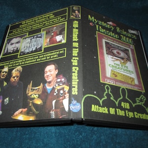 May include: A black DVD case for Mystery Science Theater 3000, episode 418: Attack of the Eye Creatures. The cover features images of the movie and the show's hosts, with the title text in green and white.