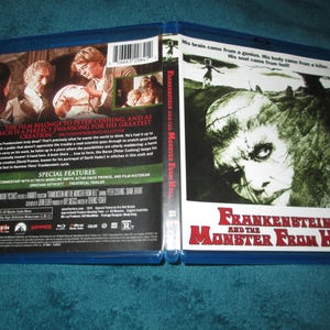 May include: Blu-ray disc case for the horror film "Frankenstein and the Monster from Hell". The front cover features a close-up of the monster's face, with the title text in red and white. The back cover features a scene from the film with Peter Cushing and the text "This film belongs to Peter Cushing, and as such is a perfect swansong for his greatest creation."