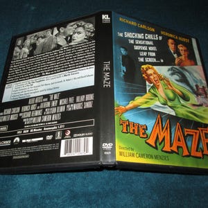 May include: DVD case for the 1953 film "The Maze." The cover features a woman in a green dress, with the title in orange and green. The case is open, revealing the back with cast and crew information.