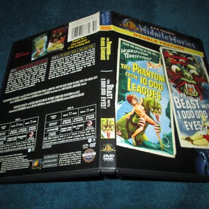 May include: A DVD case with a double feature of two horror films: "The Phantom From 10,000 Leagues" and "The Beast With 1,000,000 Eyes". The front cover features a monster with glowing red eyes and a woman in a bikini.