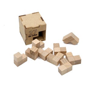 May include: A wooden puzzle with 27 pieces, including a cube-shaped container with the number "27" printed on it. The puzzle pieces are scattered around the container, showcasing the disassembled state of the puzzle. The natural wood colour gives it a classic look.