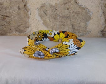 wire headband with flowers in yellow, brown, beige, black, and white