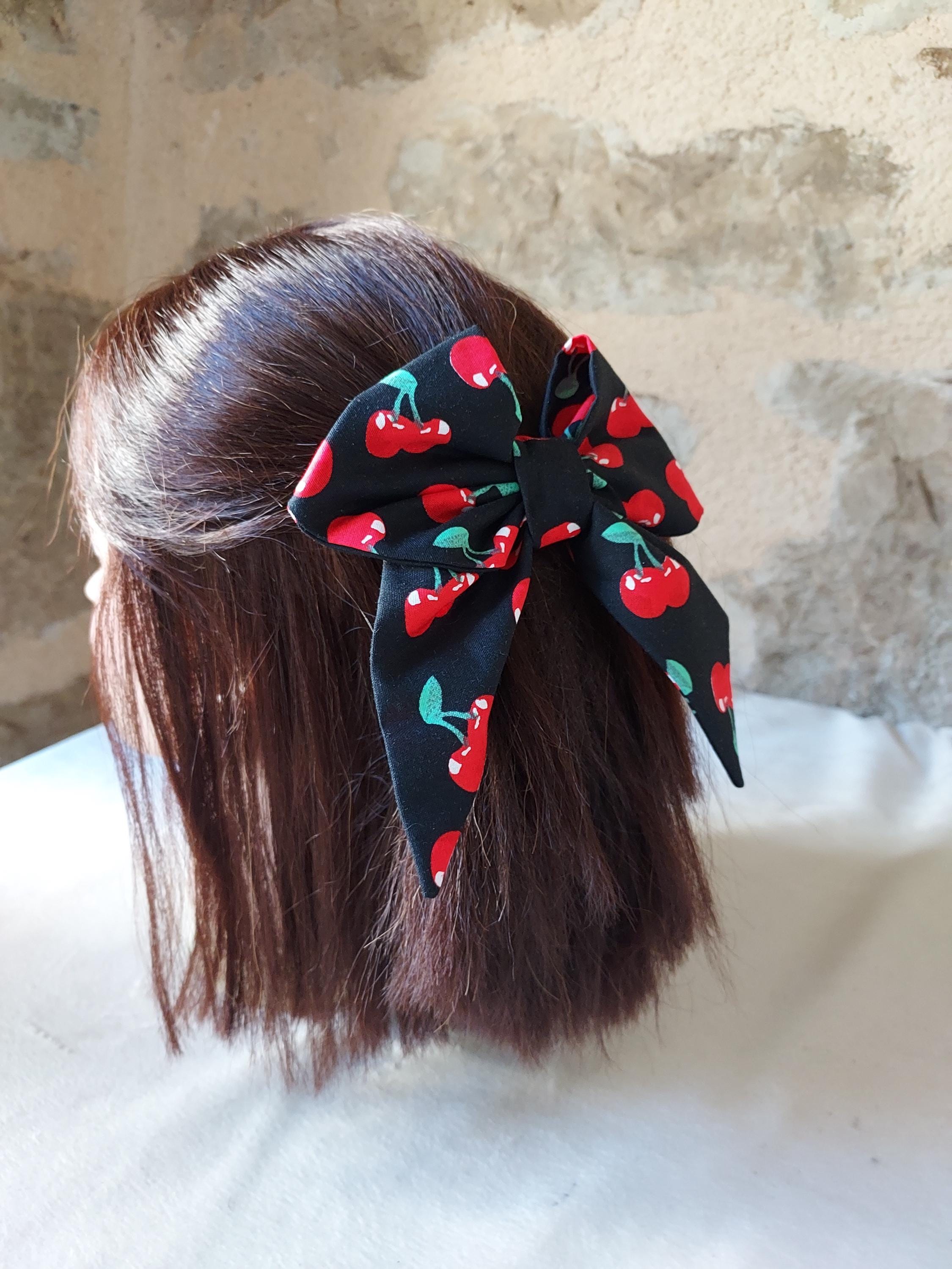 Cherry bow barrette with black background