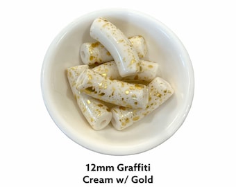 Perles tubulaires en acrylique crème : éclaboussures de peinture graffiti dorées (12 mm)