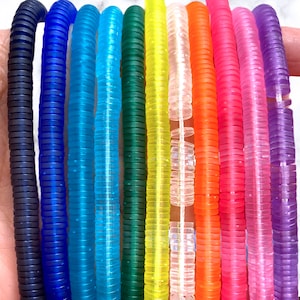 May include: A set of ten colorful, translucent, plastic bracelets. Each bracelet is made of stacked, round beads. The colors are navy blue, light blue, turquoise, green, yellow, clear, orange, pink, hot pink, and purple.