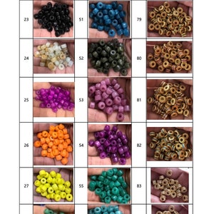 May include: A selection of small, coloured beads in various shades, including blue, black, white, purple, orange, yellow, and green. The beads are displayed in small piles, showcasing their diverse colours and textures. Suitable for jewellery making and crafts.