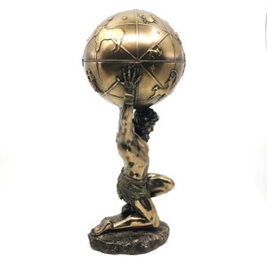 May include: A bronze sculpture of a kneeling figure holding a globe on their shoulders. The globe is decorated with constellations and zodiac symbols.