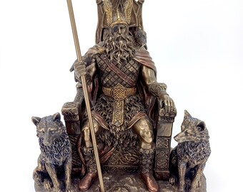 May include: A bronze statue of Odin, the Norse god of wisdom, war, and death, sitting on a throne with two wolves at his feet. He is holding a spear and wearing a horned helmet. The statue is labeled "Odin".