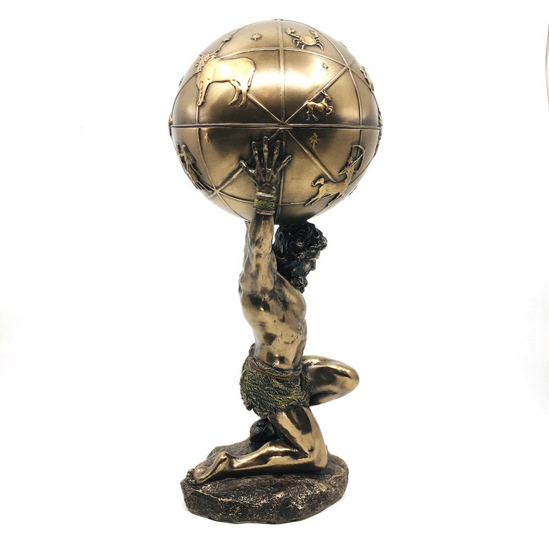 May include: A bronze sculpture of a kneeling figure holding a globe on their shoulders. The globe is decorated with constellations and zodiac symbols.