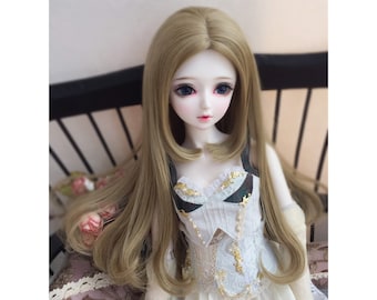 May include: A doll with long, light brown hair styled in a layered cut. The doll is wearing a white dress with gold accents and a black and white patterned bodice.