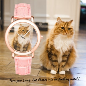 May include: A pink leather wristwatch with a rose gold face and a cat image inside the watch face. The watch is on a wooden surface. Turn your Lovely Cat Photos into an Amazing watch!