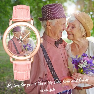 May include: A pink wristwatch with a round face featuring a photo of an older couple. The watch has a crocodile-embossed leather band. The text "My love for you is like a big tree, firm and full of strength" is printed below the watch.