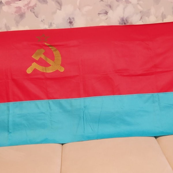 A large red banner with a star, hammer and sickle.Ukrainian republican flag. Original 100%! Vintage red flag from the 1980s.