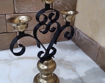 Beautiful metal candlestick with 3 branches.Candlestick in Indian style on a leg.Old metal candlestick.Festive candles.wedding gift.