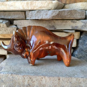 Vintage ceramic sculpture of a buffalo in brown color. Miniature hand-painted figurine Buffalo Buffalo Calf. 1960s USSR. Present.