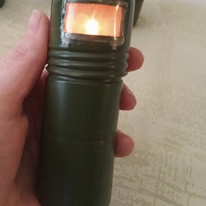 Antique olive-coloured pocket torch. Tactical flashlight. Soldier&#39;s flashlight. Lantern decor