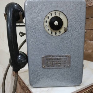 Vintage street payphone in grey. Retro phone. Metal set for a payphone. A real card phone. Ideas for a gift. office decor