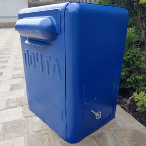 Blue metal mailbox. Vintage box for letters and newspapers. USSR mailbox in the 80s.