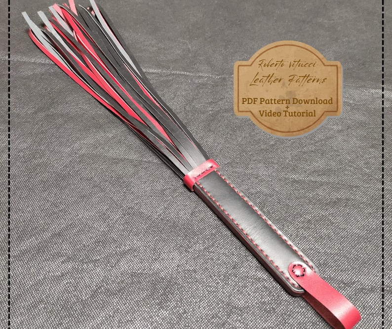 May include: A black and red leather whip with a black handle and red stitching. The whip has a fringe of black and red leather strips. The image includes the text "Roberto Vitucci Leather Patterns" and "PDF Pattern Download + Video Tutorial".