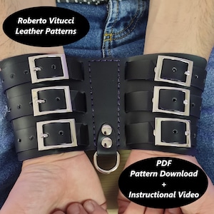 May include: Black leather wrist restraints with three silver buckles and a D-ring. The restraints are connected by a central strap. The image includes the text "Roberto Vitucci Leather Patterns" and "PDF Pattern Download + Instructional Video."