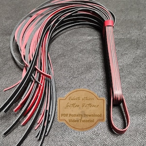 May include: A black and red leather whip with a braided handle. The whip is made of multiple strands of leather that are woven together. The handle is decorated with a red stripe. The whip is a craft project and includes a PDF pattern download and video tutorial.  Roberto Vitucci Leather Patterns.