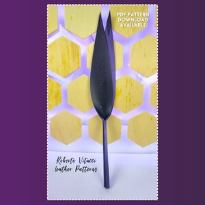 May include: A dark gray leather pattern shaped like a leaf, with a long stem, set against a background of yellow honeycomb shapes. The text "PDF PATTERN DOWNLOAD AVAILABLE" is visible. The text "Roberto Vitucci leather Patterns" is also visible.