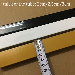 May include: Close-up of a gold, white, and black metal tube. A measuring tape shows the tube is 3 cm thick. The text "Color: gold/white/black" and "thick of the tube: 2cm/2.5cm/3cm" is visible in the image.