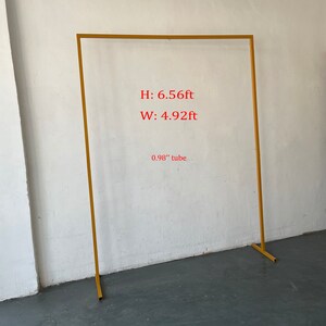 May include: Gold metal archway with a 6.56 ft height and 4.92 ft width. The archway is made of 0.98 inch diameter tubing.