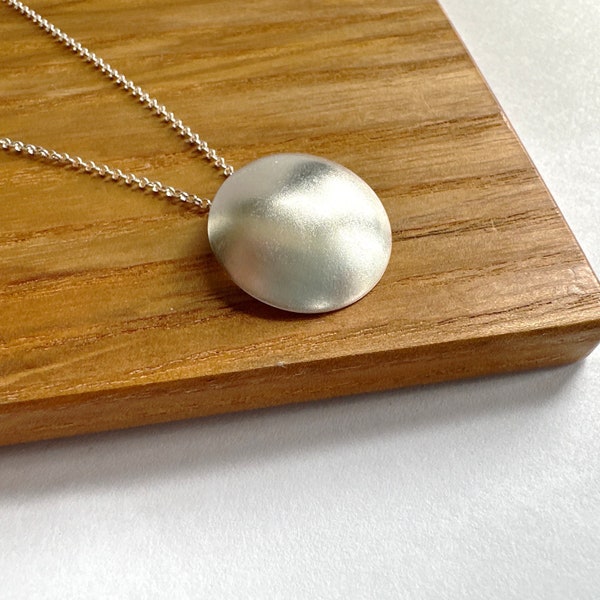 Full Moon Curved circle necklace with a frosted satin finish , Domed sterling silver pendant