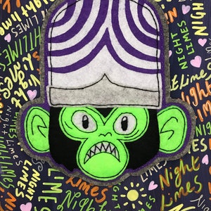 May include: A green felt character with a black felt face and a purple and white striped felt hat. The character has a large, toothy grin and is surrounded by a dark blue background with the words "Night Limes" written in various colours.