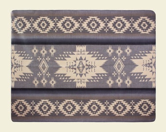 May include: A gray and beige patterned throw blanket with a geometric design.