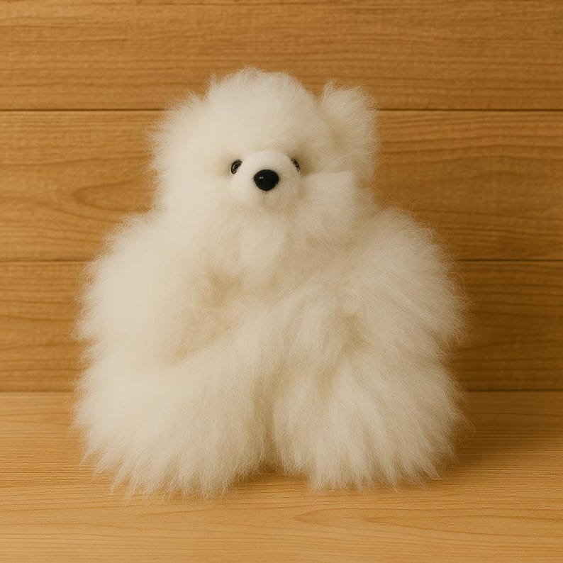 May include: A fluffy, white teddy bear with a round body and small black eyes. The bear is made of soft, plush material and has a friendly, inviting appearance. The toy is a classic children's item.