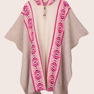 May include: A white hooded poncho with pink and purple geometric patterns. The poncho has a fringe trim.