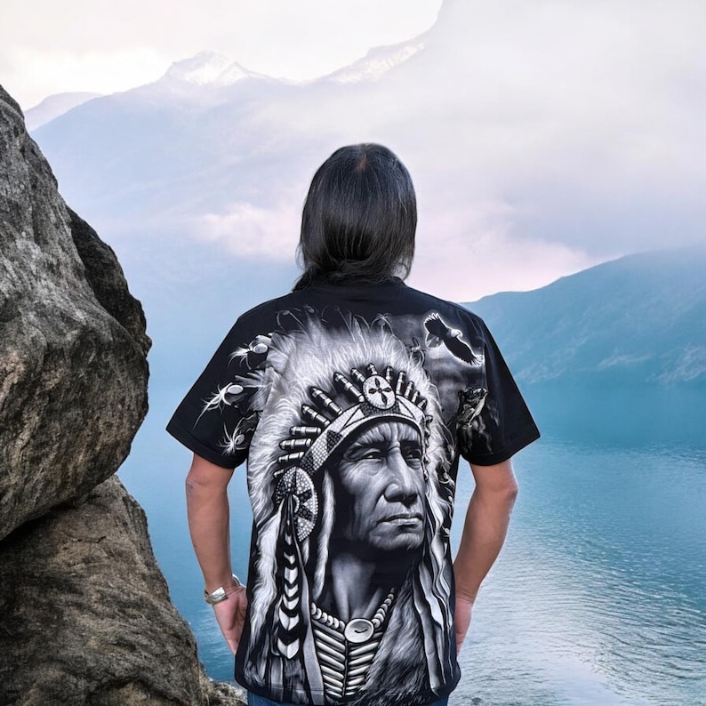 May include: A black t-shirt with a graphic print of a Native American chief wearing a headdress. The chief's face is detailed and the headdress is adorned with feathers.