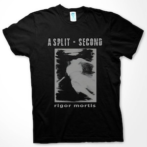 May include: Black t-shirt with the text "A SPLIT = SECOND" above a grayscale image and the words "rigor mortis" below. The image appears to be a blurred figure. The shirt has a crew neck and short sleeves.