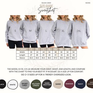 May include: A size guide for Gildan 18000 sweatshirts, featuring models wearing gray sweatshirts in sizes S to 2XL. The guide includes measurements in inches for width, length, and sleeve. Color options include black, white, sport grey, military green, dark heather, sand, maroon, navy, and dark chocolate.