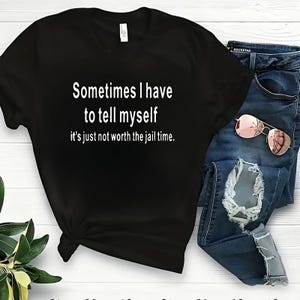 May include: Black t-shirt with white text that reads "Sometimes I have to tell myself it's just not worth the jail time."