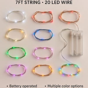 May include: Battery-operated fairy lights with a 7-foot string and 20 LED lights. The image shows multiple color options, including white, red, blue, green, pink, and yellow. The flexible, bendable wire is suitable for indoor or outdoor use.