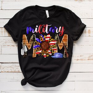 May include: Black t-shirt featuring a sunflower design and the text "military mom". The sunflower has red, white and blue petals and a leopard print centre. The design also includes camouflage, dog tags and a military hat.