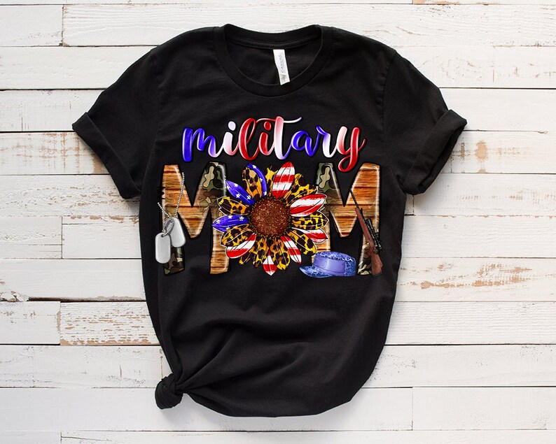 May include: Black t-shirt featuring a sunflower design and the text "military mom". The sunflower has red, white and blue petals and a leopard print centre. The design also includes camouflage, dog tags and a military hat.