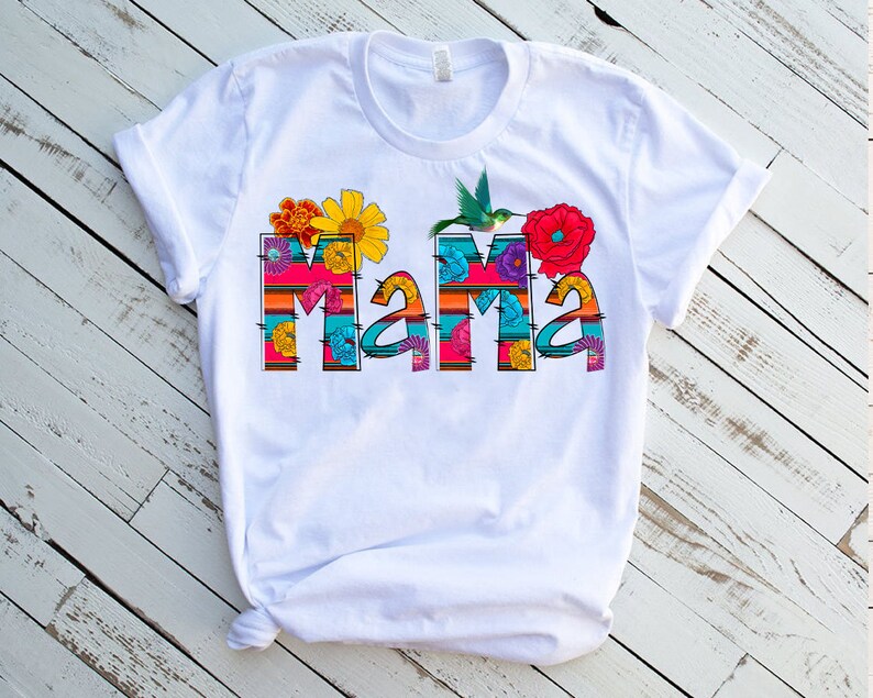 May include: White t-shirt with a colorful floral design that spells out "Mama".