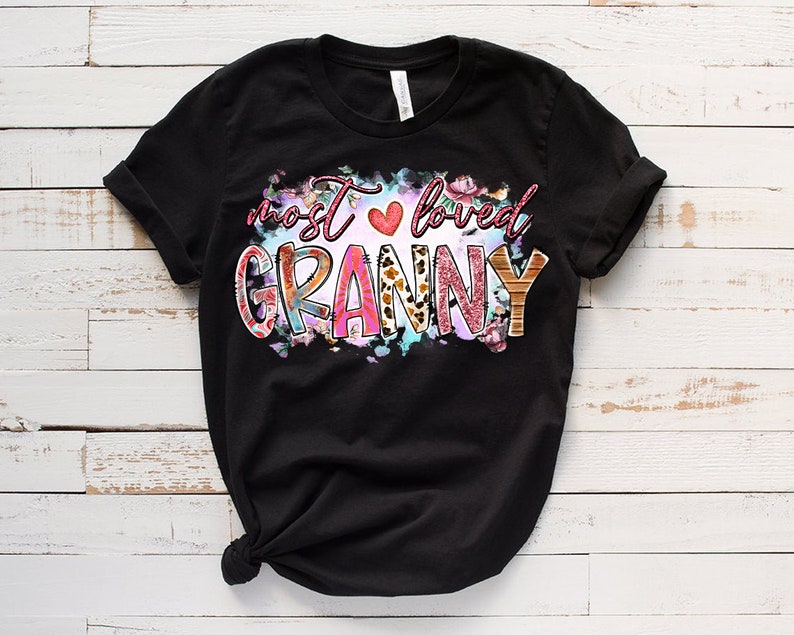 May include: Black t-shirt with a colorful graphic that says "most loved granny" with a pink heart and floral accents.