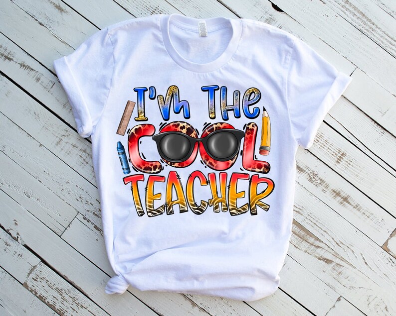 May include: White t-shirt with the text "I'm the Cool Teacher" in colorful letters with a pair of sunglasses and school supplies.
