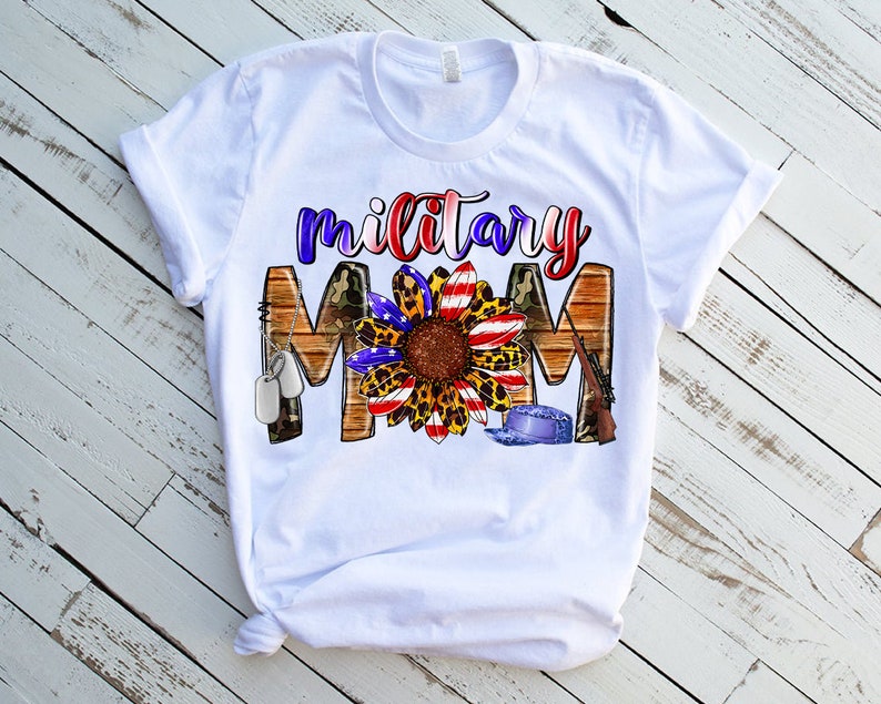 May include: White t-shirt featuring a sunflower graphic with red, white and blue accents, camouflage, and the text "military mom".