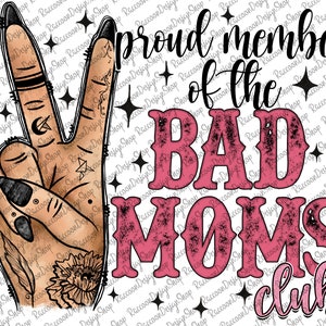 May include: A digital illustration of a hand making the peace sign. The hand has black nail polish and tattoos. The text "Proud member of the Bad Moms Club" is in pink and black with a distressed look.