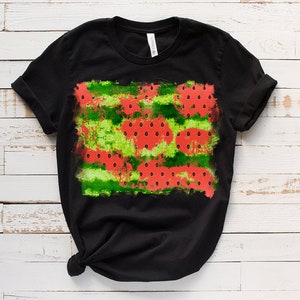 May include: Black t-shirt with a watermelon print. The print features red watermelon slices with black seeds on a green and white background.