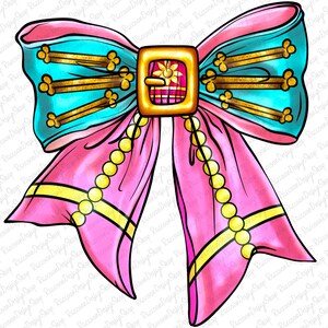 May include: A large pink bow with a turquoise center and gold accents. The bow has a gold buckle with a floral design and a string of gold beads.
